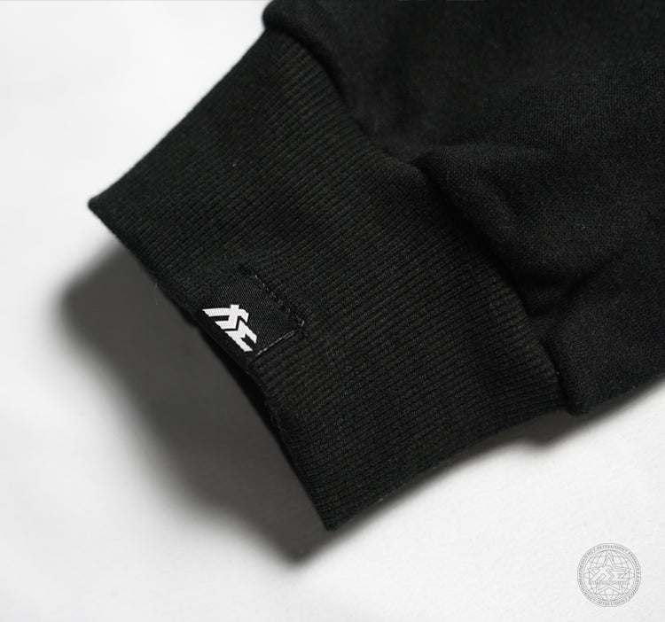 Fi EXHAUST authenticity patch on a black hoodie's cuff.