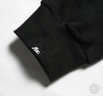 Load image into Gallery viewer, Fi EXHAUST authenticity patch on a black hoodie&#39;s cuff.
